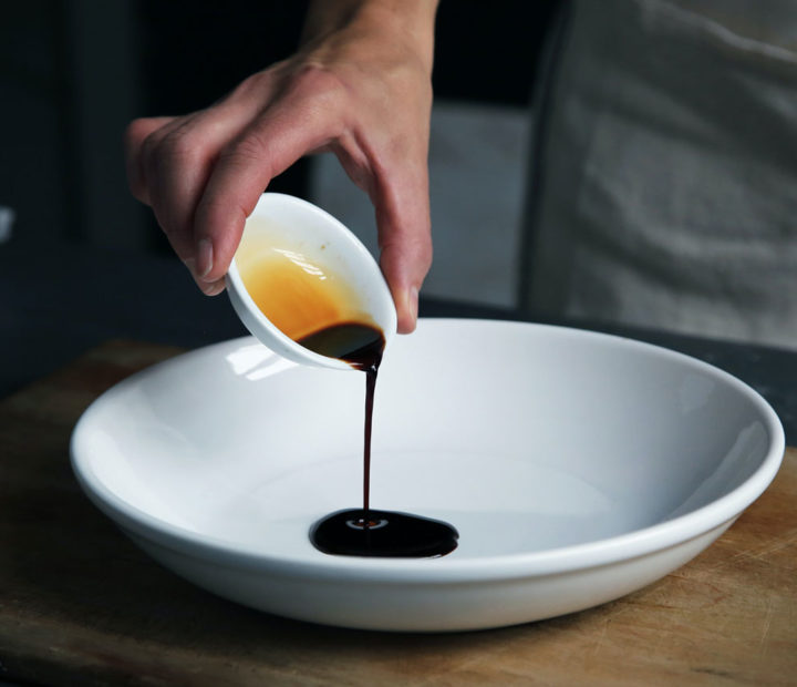 Japanese sauce being poured in an empty white bowl